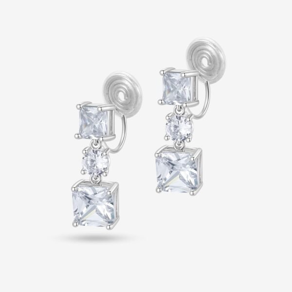 A pair of elegant silver earrings with square and round clear gemstones, featuring a swirled silver backing and a drop design against a white background.
