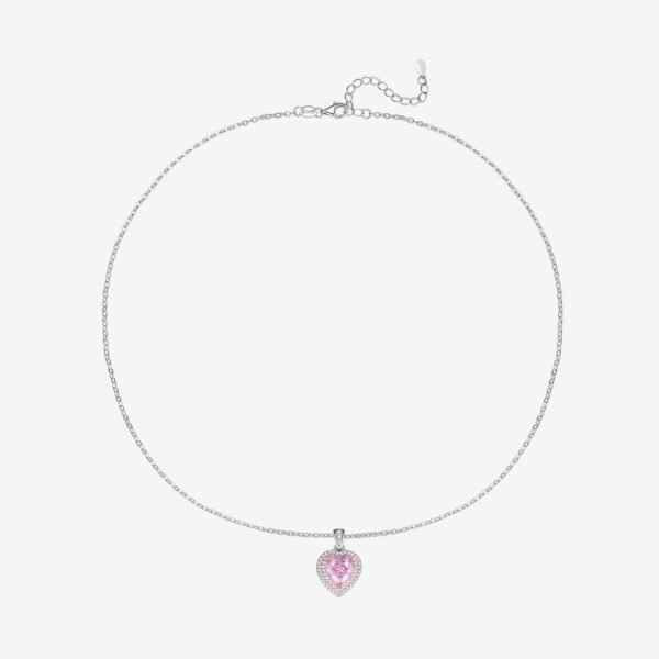 A delicate silver necklace with a heart-shaped pendant. The pendant features a pink gemstone surrounded by smaller clear gemstones, offering a sparkling, elegant design against a plain white background.