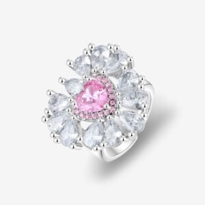 A luxurious ring featuring a central heart-shaped pink gem surrounded by smaller pear-shaped clear stones in a floral arrangement, set in a shiny silver band on a white background.