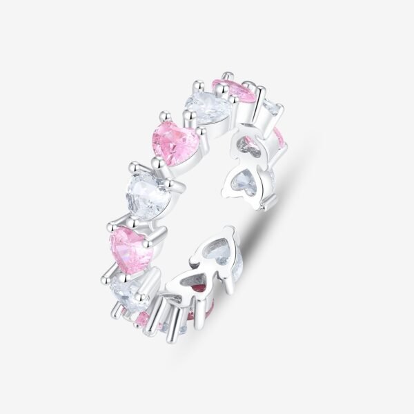 Introducing the Eternal Love Ring: a silver band adorned with alternating heart-shaped gemstones in pink and clear hues. These sparkling stones encircle the ring, symbolizing an eternal bond. The design is beautifully captured against a plain white background.