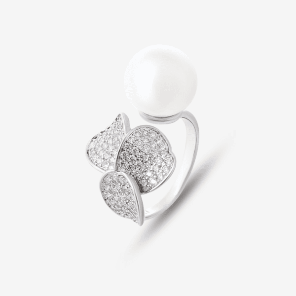A silver ring featuring a large white pearl and three leaf-shaped embellishments adorned with small sparkling crystals. The ring has an elegant, floral-inspired design against a plain white background.